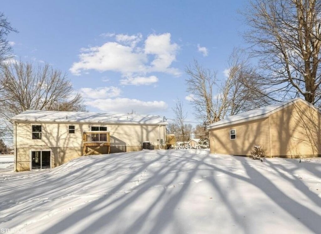 yard covered in snow featuring a deck