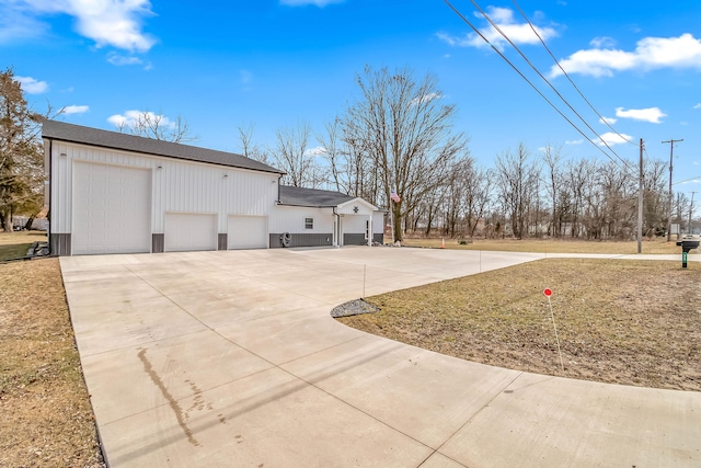 view of property exterior featuring a detached garage