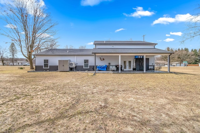 back of property with french doors, a lawn, a shingled roof, and a patio area