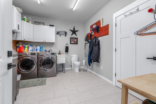 laundry room featuring cabinet space, independent washer and dryer, and baseboards