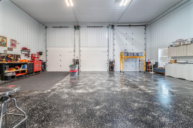 garage with a workshop area and metal wall