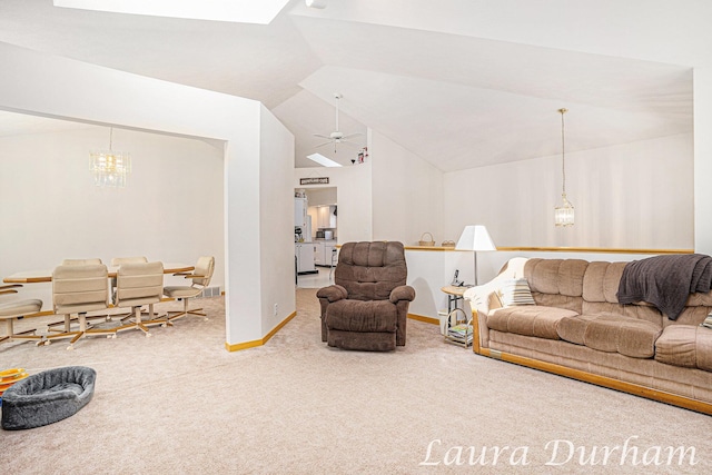 living area with carpet flooring, baseboards, a ceiling fan, and vaulted ceiling