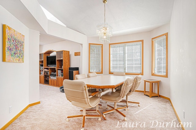 dining area featuring baseboards, carpet, lofted ceiling, and a chandelier