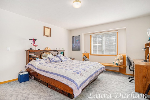 carpeted bedroom featuring baseboards