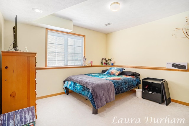 bedroom with carpet, visible vents, and baseboards