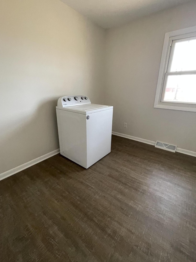 laundry area with baseboards, visible vents, washer / dryer, laundry area, and dark wood-style flooring