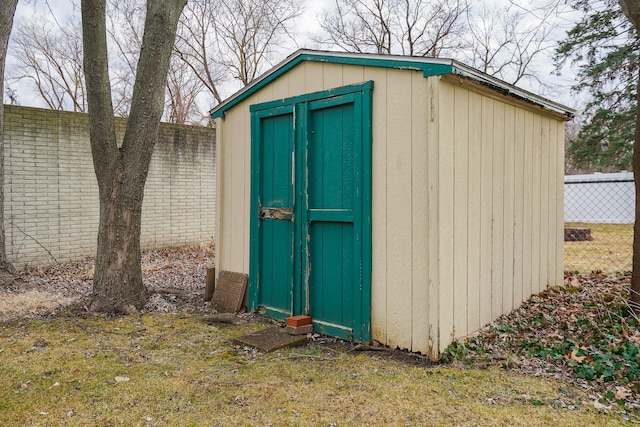 view of shed featuring fence