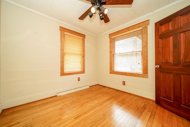 empty room with crown molding, light wood-style floors, baseboards, and baseboard heating