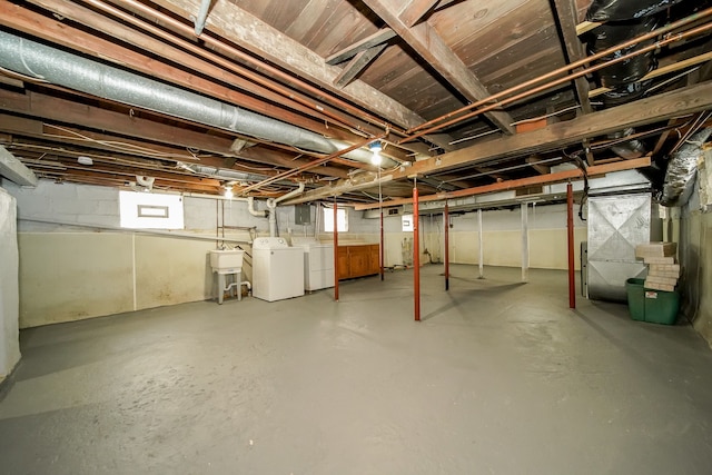 basement featuring washer and dryer and a sink