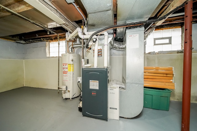 utility room featuring heating unit and gas water heater