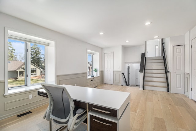 home office featuring recessed lighting, visible vents, a wainscoted wall, and light wood finished floors