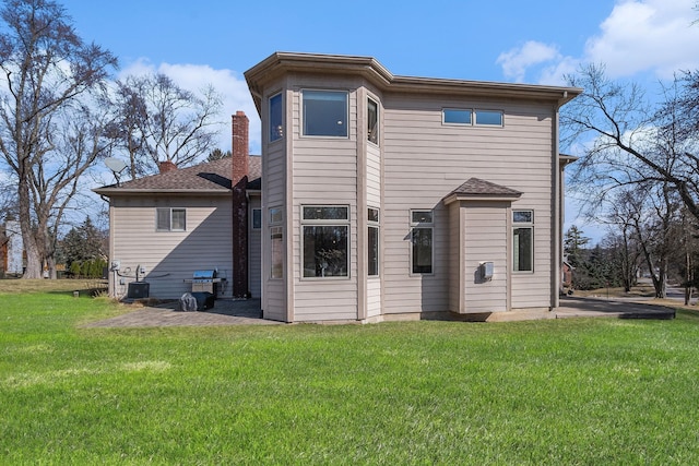 back of house with a patio, a yard, and central AC unit