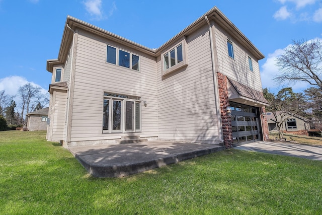 view of property exterior featuring a yard, a patio, a garage, and concrete driveway