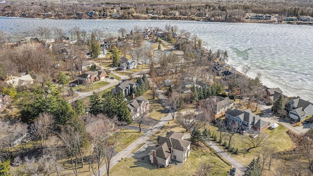 drone / aerial view with a residential view and a water view