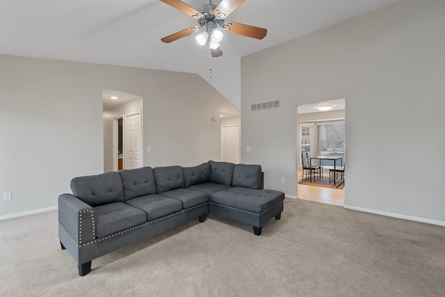 living room featuring visible vents, baseboards, high vaulted ceiling, ceiling fan, and light colored carpet