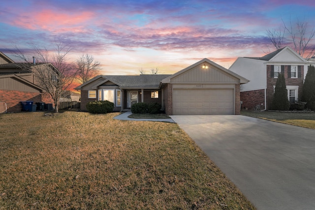 view of front of home featuring concrete driveway, an attached garage, brick siding, and a front lawn