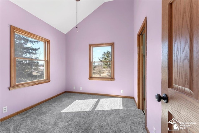 spare room with baseboards, carpet floors, and lofted ceiling