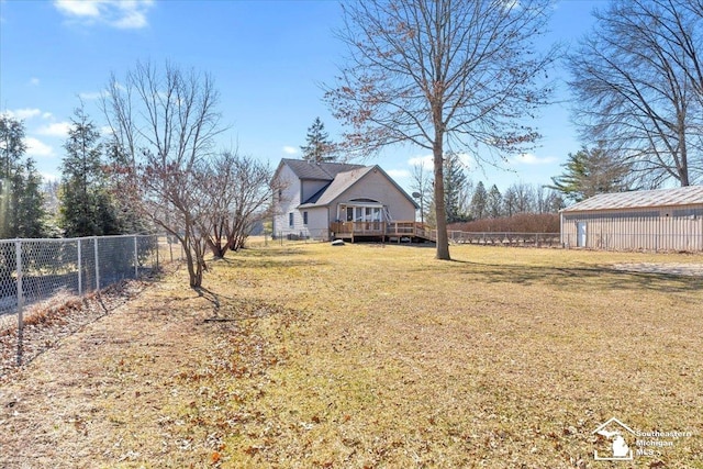 view of yard with a wooden deck and fence