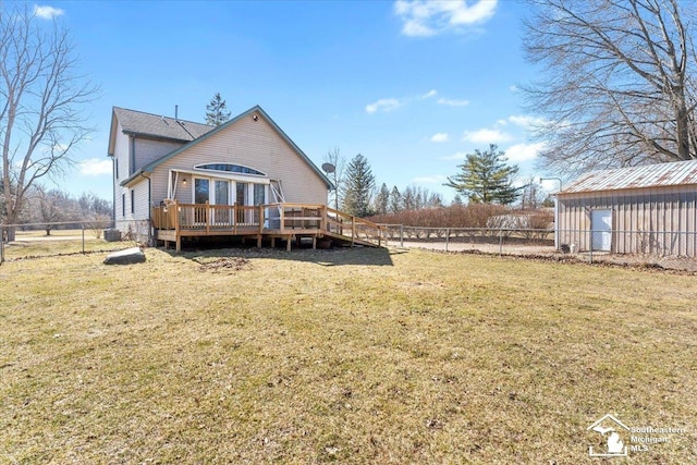 back of property with a yard, a fenced backyard, and a wooden deck