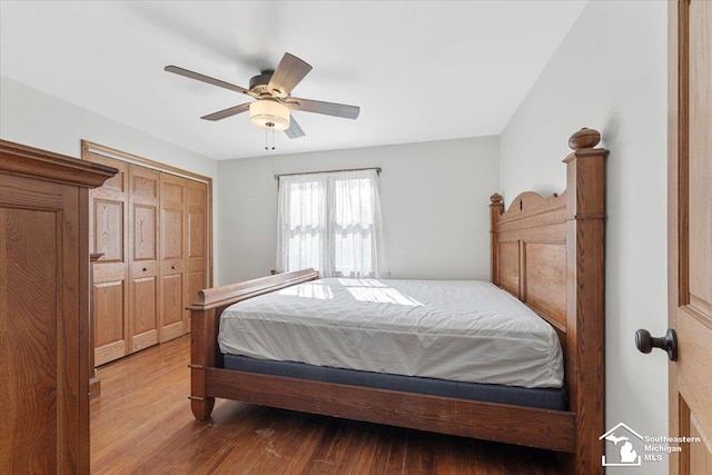 bedroom with ceiling fan, a closet, and wood finished floors