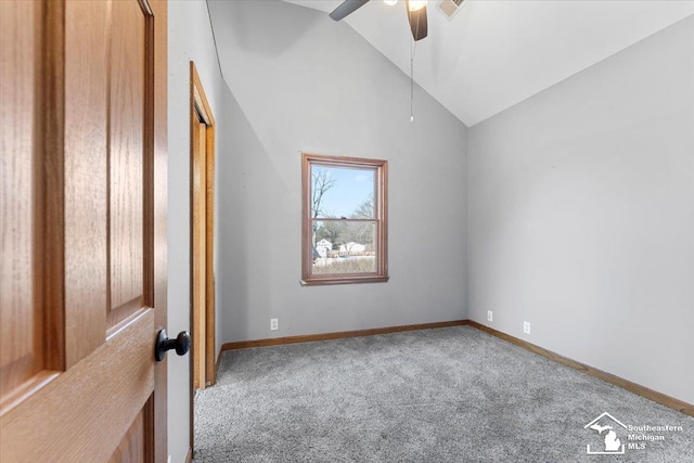 interior space featuring baseboards, carpet, ceiling fan, and high vaulted ceiling