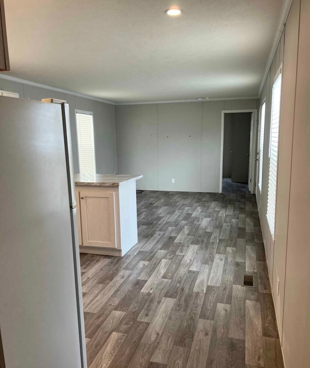 unfurnished room with wood finished floors and visible vents