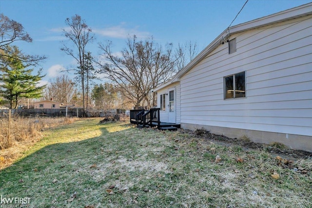 view of yard with a wooden deck and fence