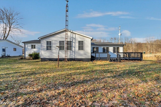 rear view of house featuring a lawn and a wooden deck