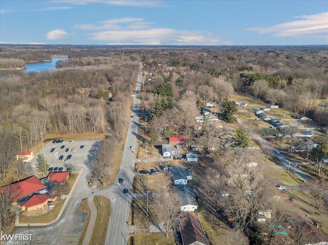 aerial view with a wooded view and a water view