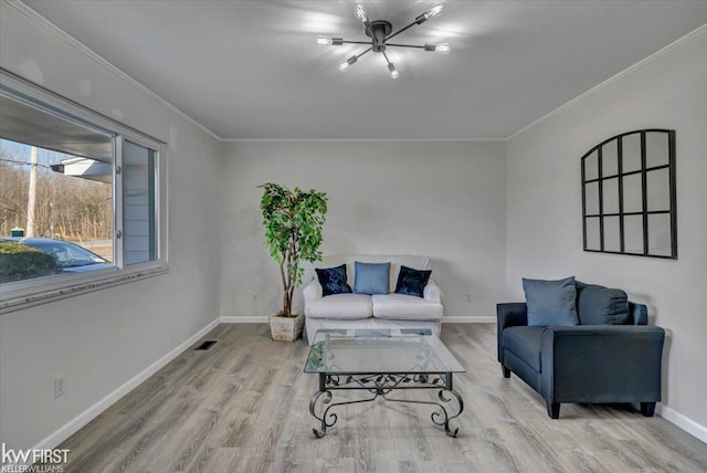 living area featuring baseboards, wood finished floors, visible vents, and ornamental molding