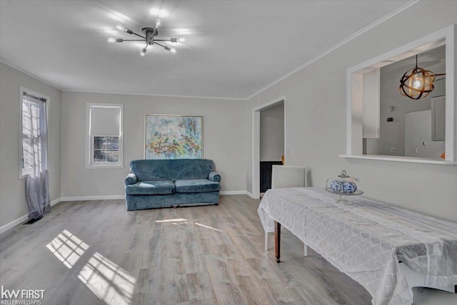 interior space with ornamental molding, baseboards, and wood finished floors