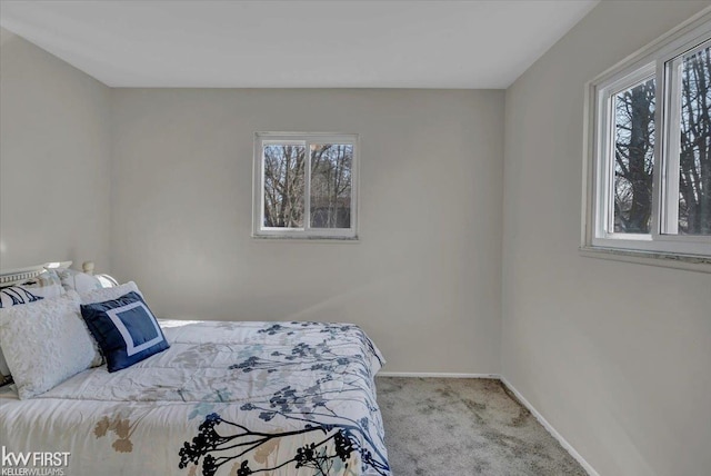 bedroom with carpet flooring and baseboards