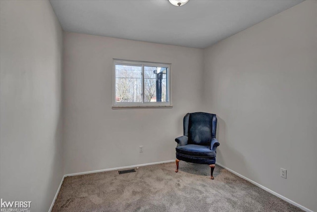 sitting room with visible vents, baseboards, and carpet