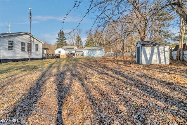 view of yard with a storage shed and an outbuilding