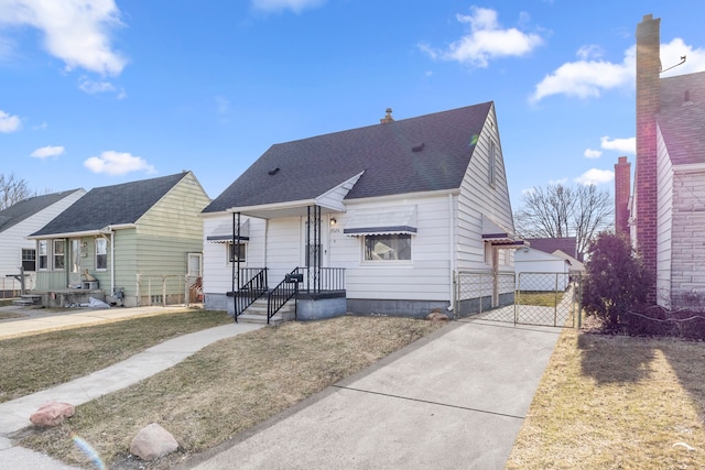 view of front of property featuring roof with shingles and a gate