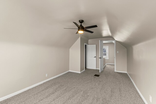 19124 Harman St, Melvindale, MI 48122 - additional living space with visible vents, baseboards, lofted ceiling, ceiling fan, and carpet flooring
