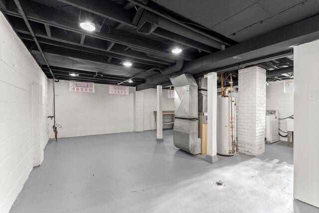 19124 Harman St, Melvindale, MI 48122 - unfinished basement featuring water heater, heating unit, and washer / clothes dryer