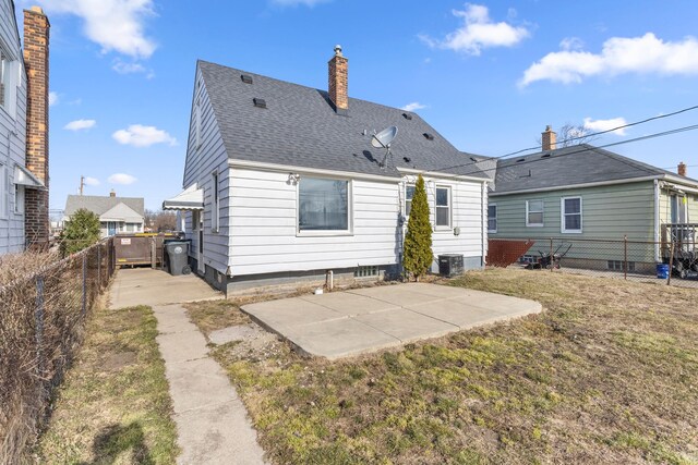 19124 Harman St, Melvindale, MI 48122 - back of property with a patio area, a lawn, a fenced backyard, and roof with shingles
