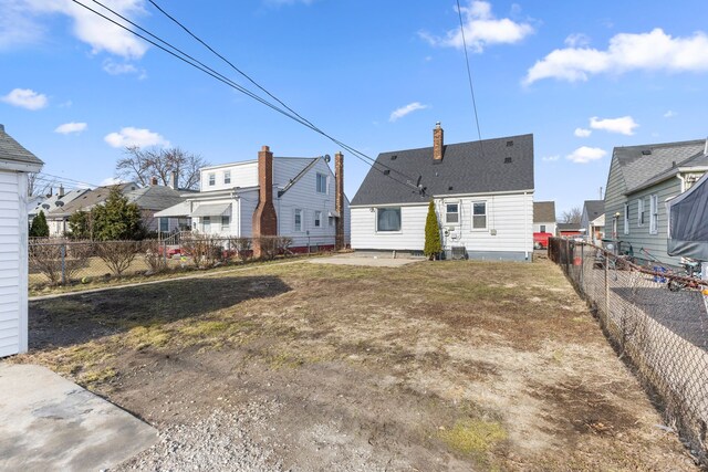 19124 Harman St, Melvindale, MI 48122 - rear view of house featuring a fenced backyard and a chimney