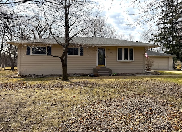 ranch-style house featuring a garage and entry steps