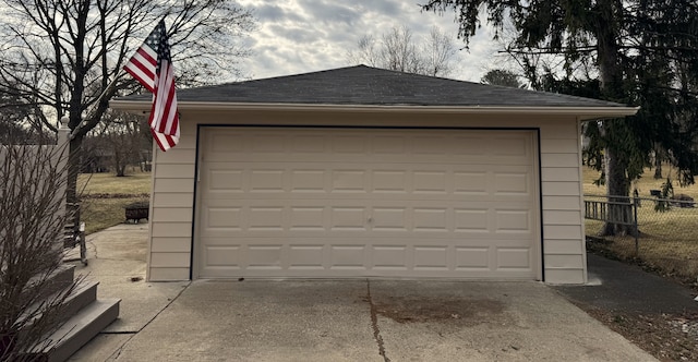 detached garage featuring fence