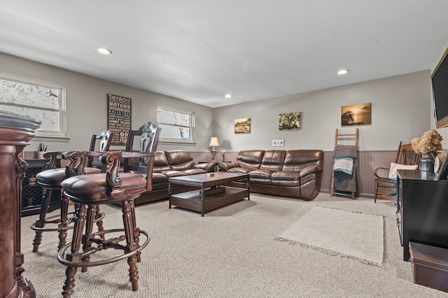 living area with carpet floors, a wainscoted wall, and recessed lighting