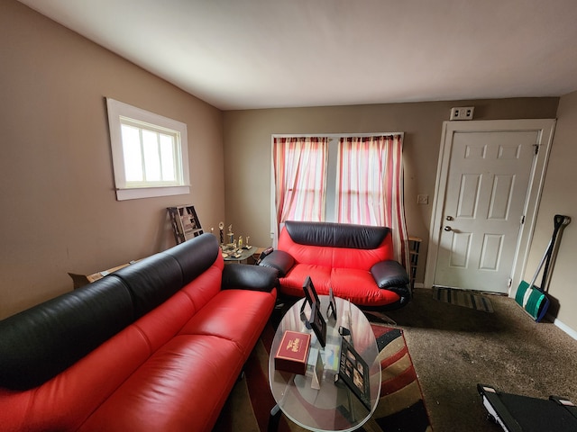 carpeted living room featuring baseboards