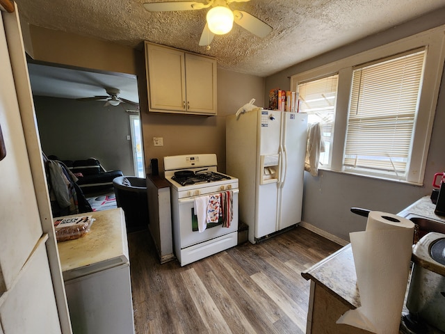 kitchen with baseboards, wood finished floors, white appliances, a textured ceiling, and a ceiling fan