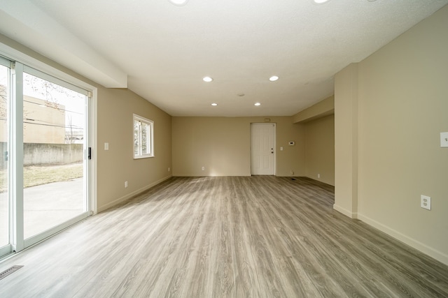 empty room featuring visible vents, recessed lighting, light wood-style floors, and baseboards