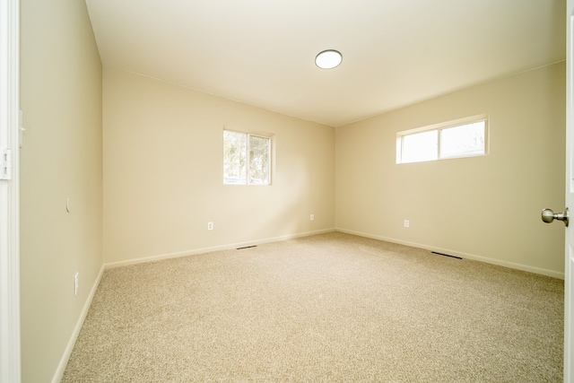 carpeted empty room with baseboards