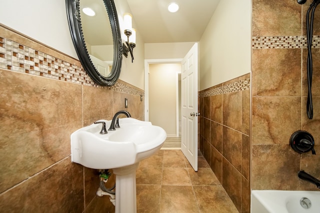 full bathroom featuring a wainscoted wall, tile walls, and shower / bathing tub combination