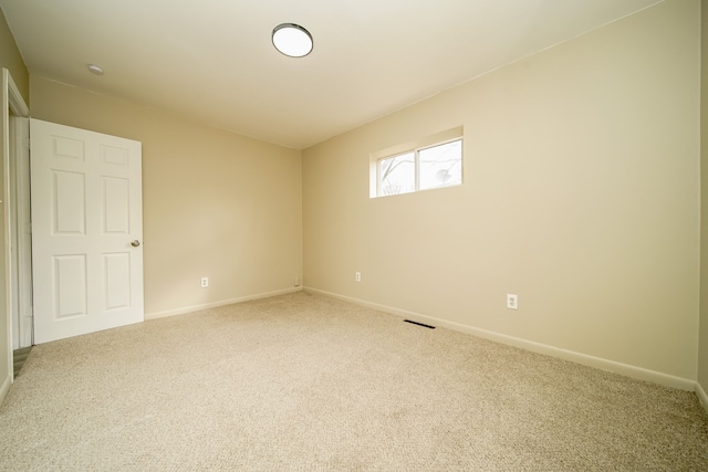 unfurnished room featuring baseboards and carpet floors