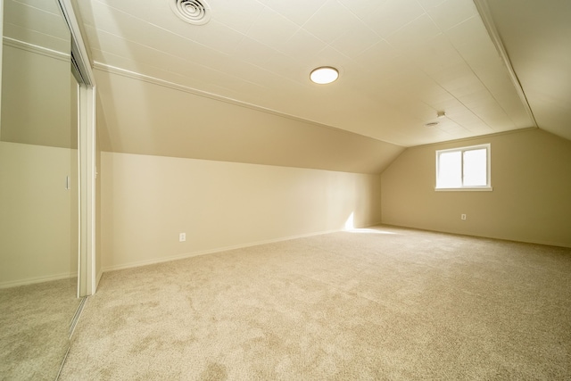 bonus room with lofted ceiling, carpet flooring, baseboards, and visible vents