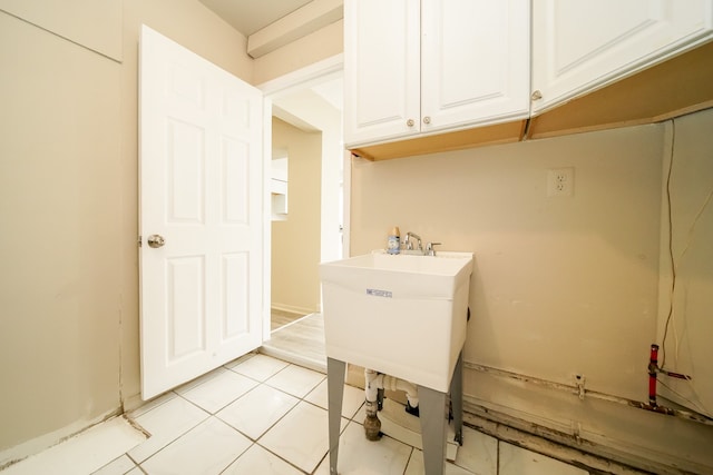 washroom with light tile patterned floors and a sink